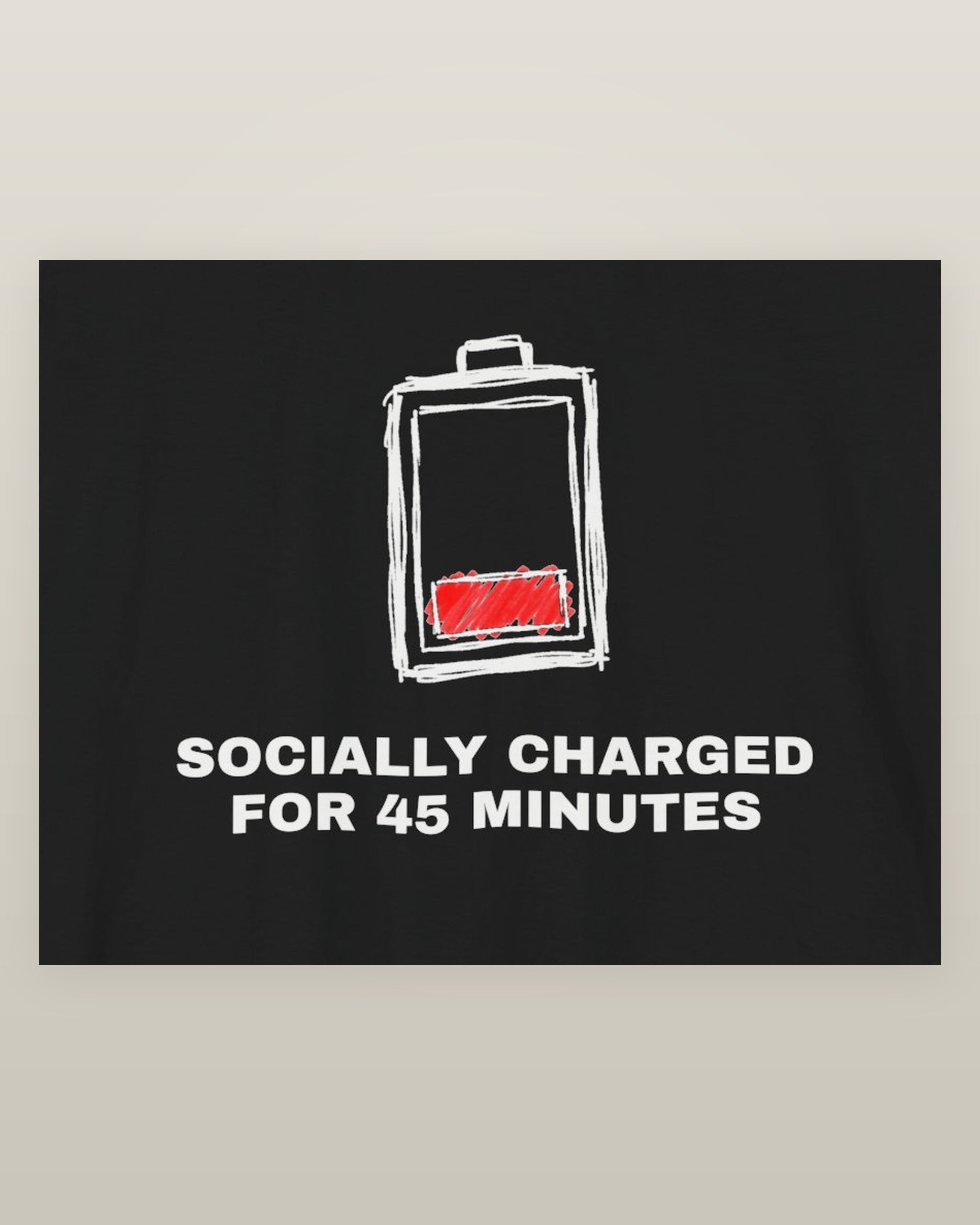 Socially charged for 45 minutes — a battery drained to its last bar, printed on a black cotton t-shirt, close detail of the print