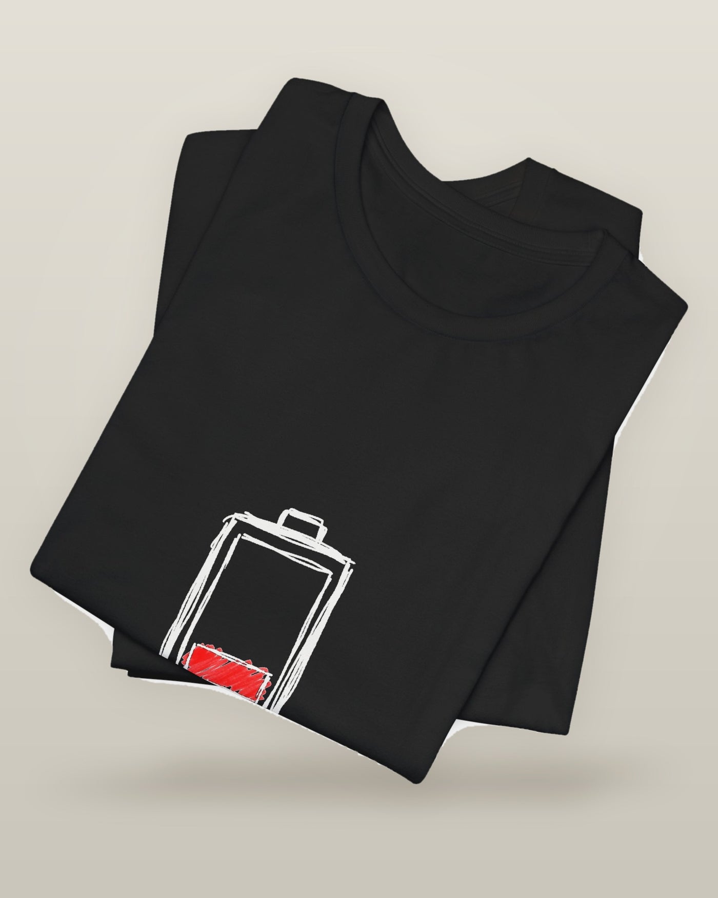Socially charged for 45 minutes — a battery drained to its last bar, printed on a black cotton t-shirt, folded