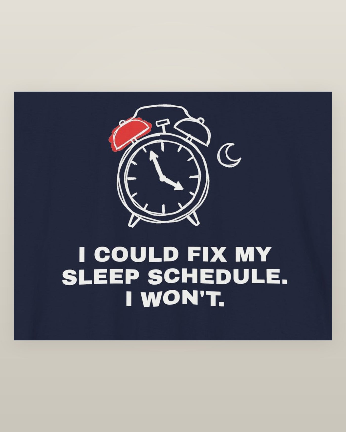 I could fix my sleep schedule. I won't. — an alarm clock at a very late hour beside a crescent moon, printed on a navy cotton t-shirt, close detail of the print