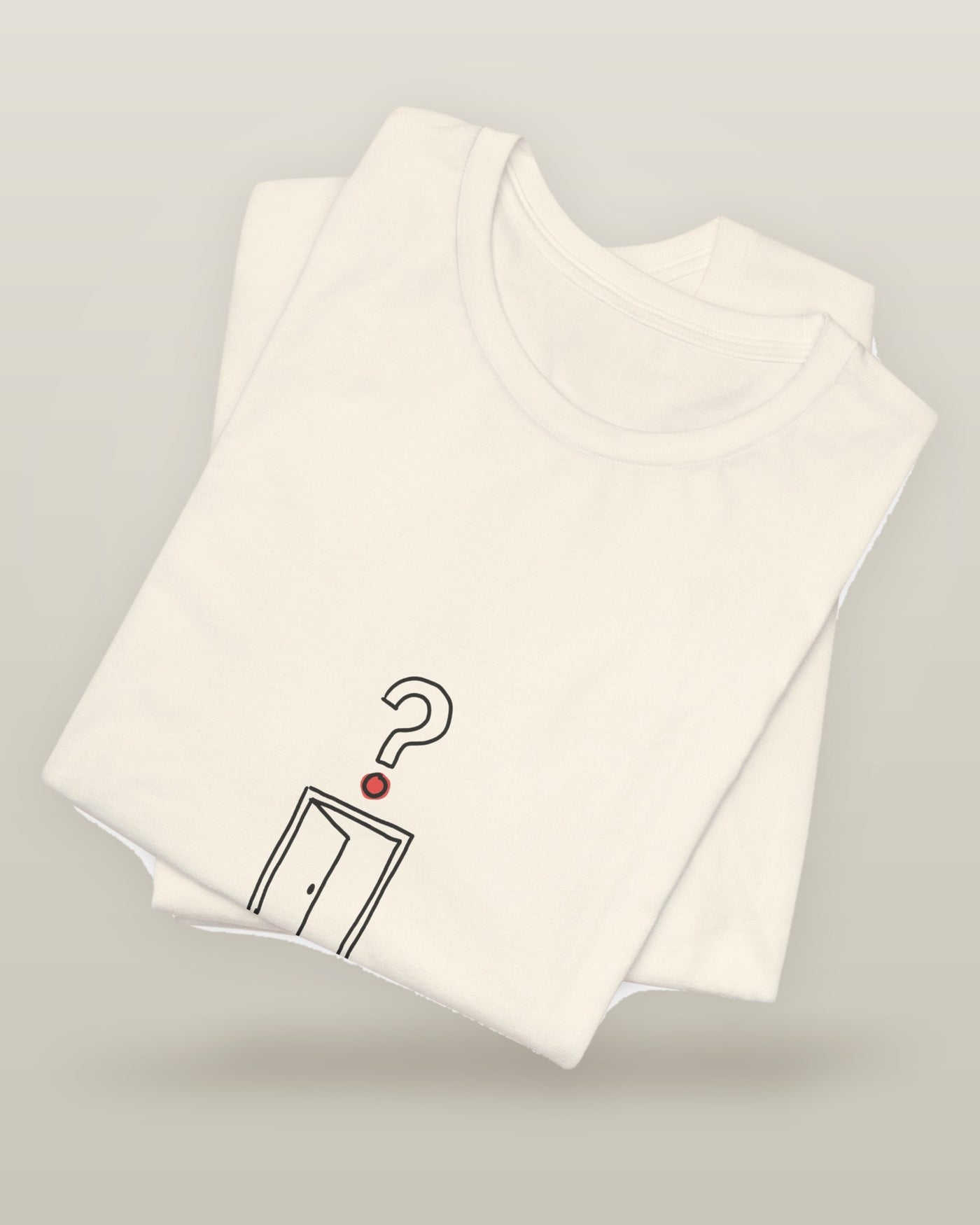 I came, I saw, I forgot why — an empty doorway with a question mark above it, printed on a natural cream cotton t-shirt, folded