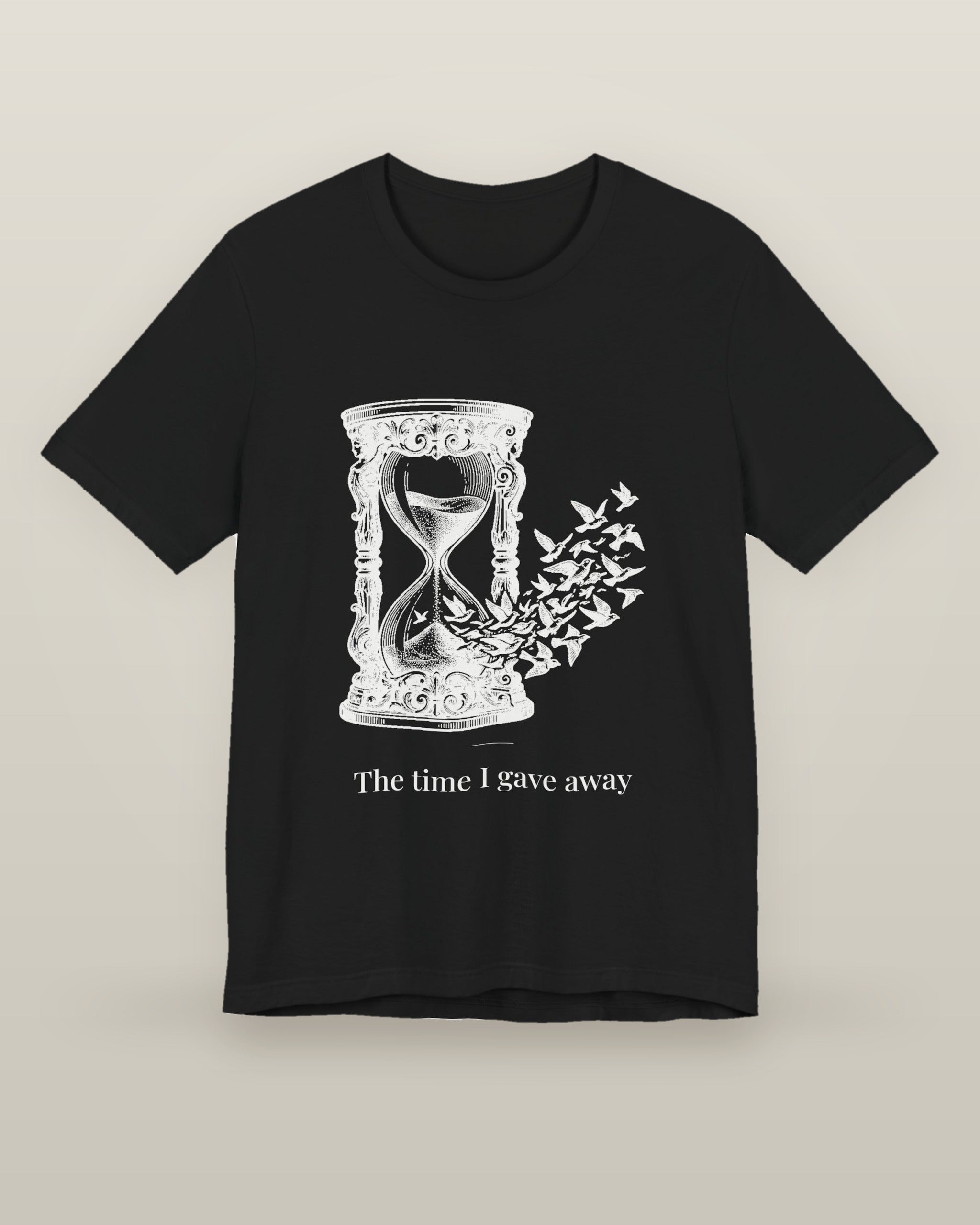 The time I gave away — an hourglass whose falling sand becomes a flock of birds, printed on a black cotton t-shirt, front view