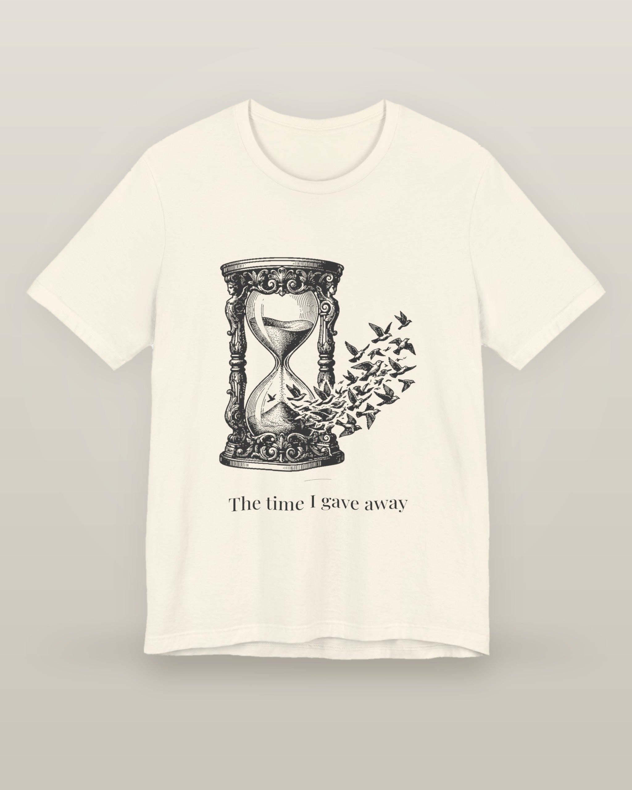 The time I gave away — an hourglass whose falling sand becomes a flock of birds, printed on a natural cream cotton t-shirt, front view