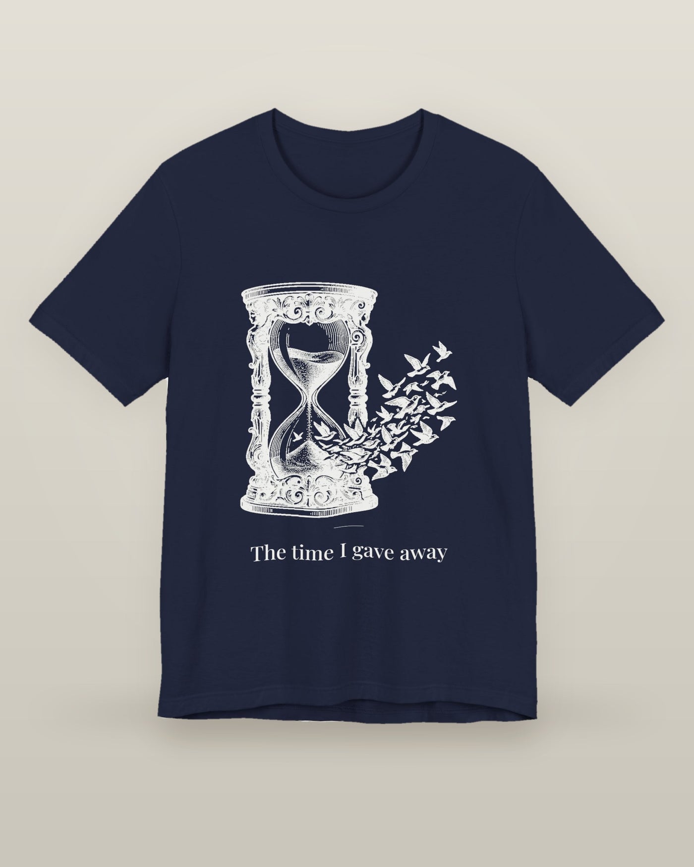 The time I gave away — an hourglass whose falling sand becomes a flock of birds, printed on a navy cotton t-shirt, front view