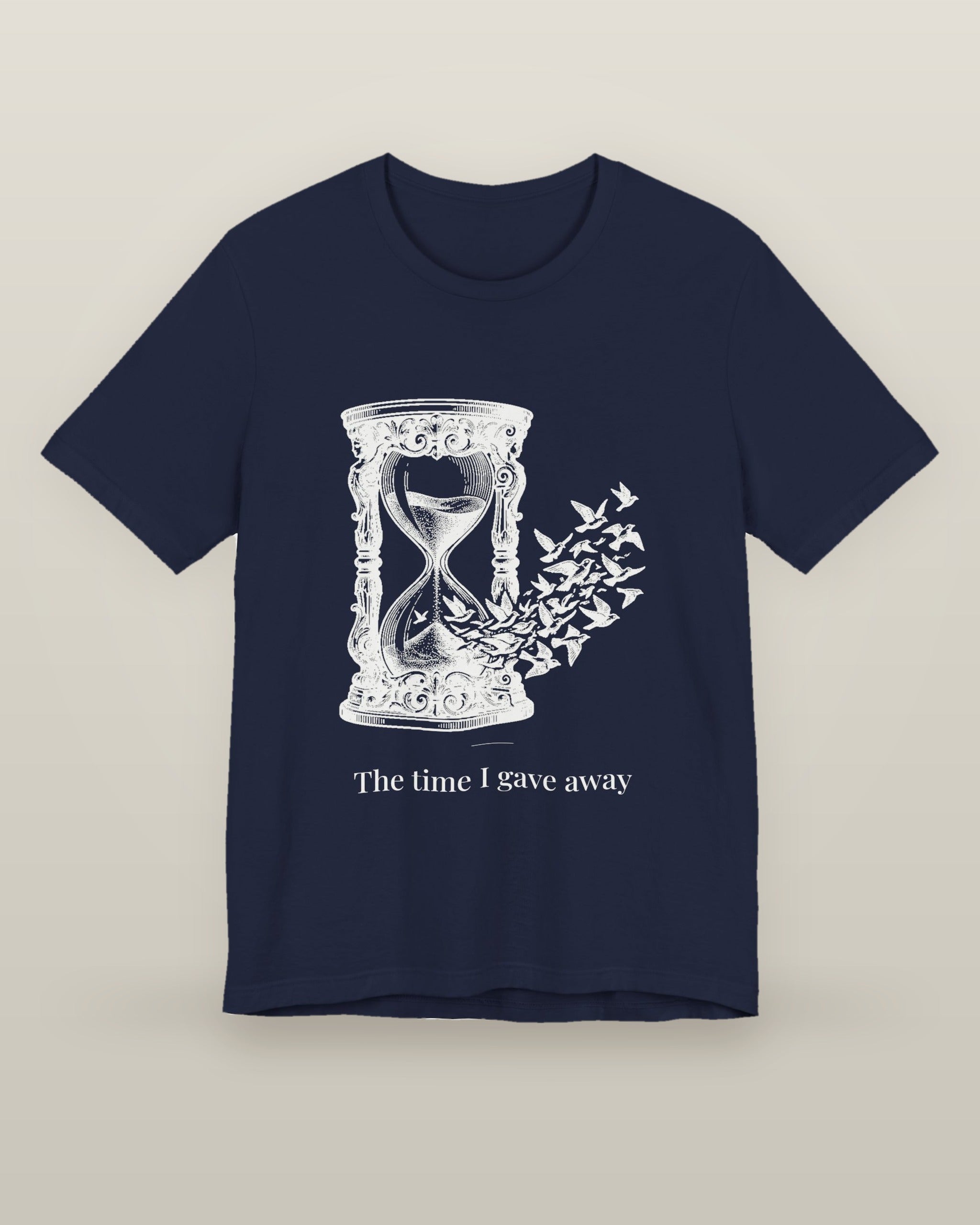 The time I gave away — an hourglass whose falling sand becomes a flock of birds, printed on a navy cotton t-shirt, front view