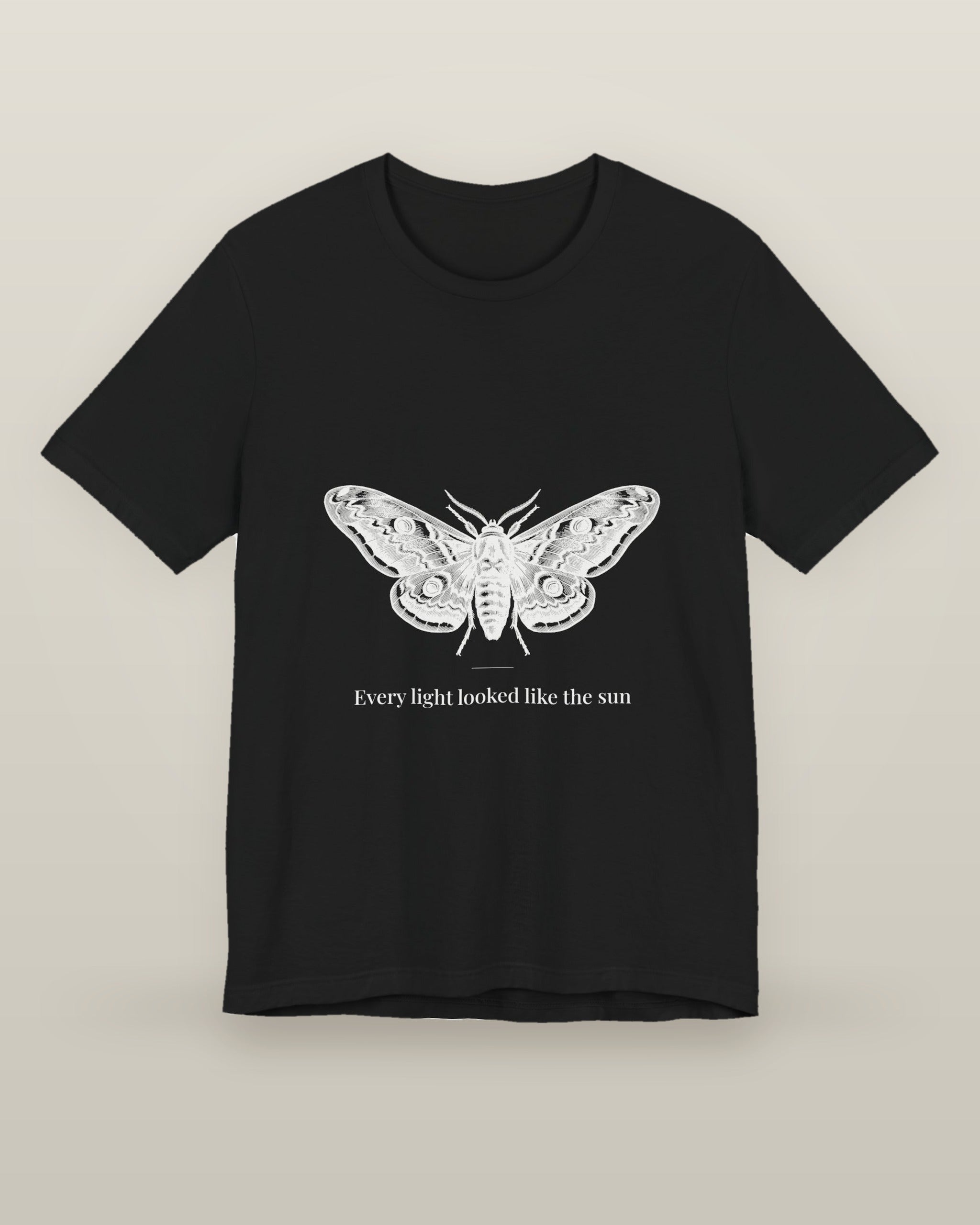 Every light looked like the sun — a moth specimen study, wings spread, printed on a black cotton t-shirt, front view