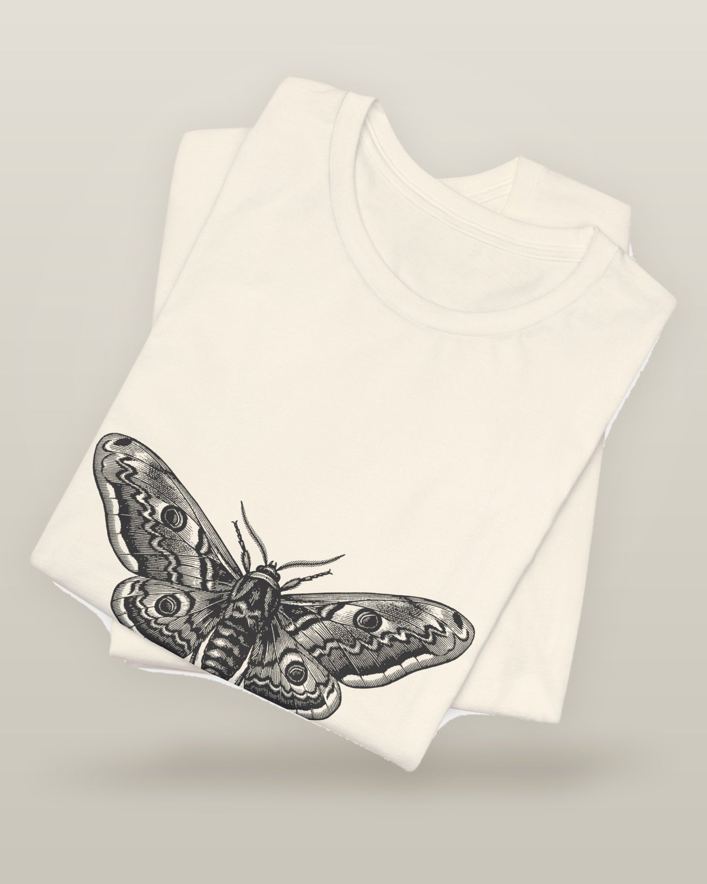 Every light looked like the sun — a moth specimen study, wings spread, printed on a natural cream cotton t-shirt, folded