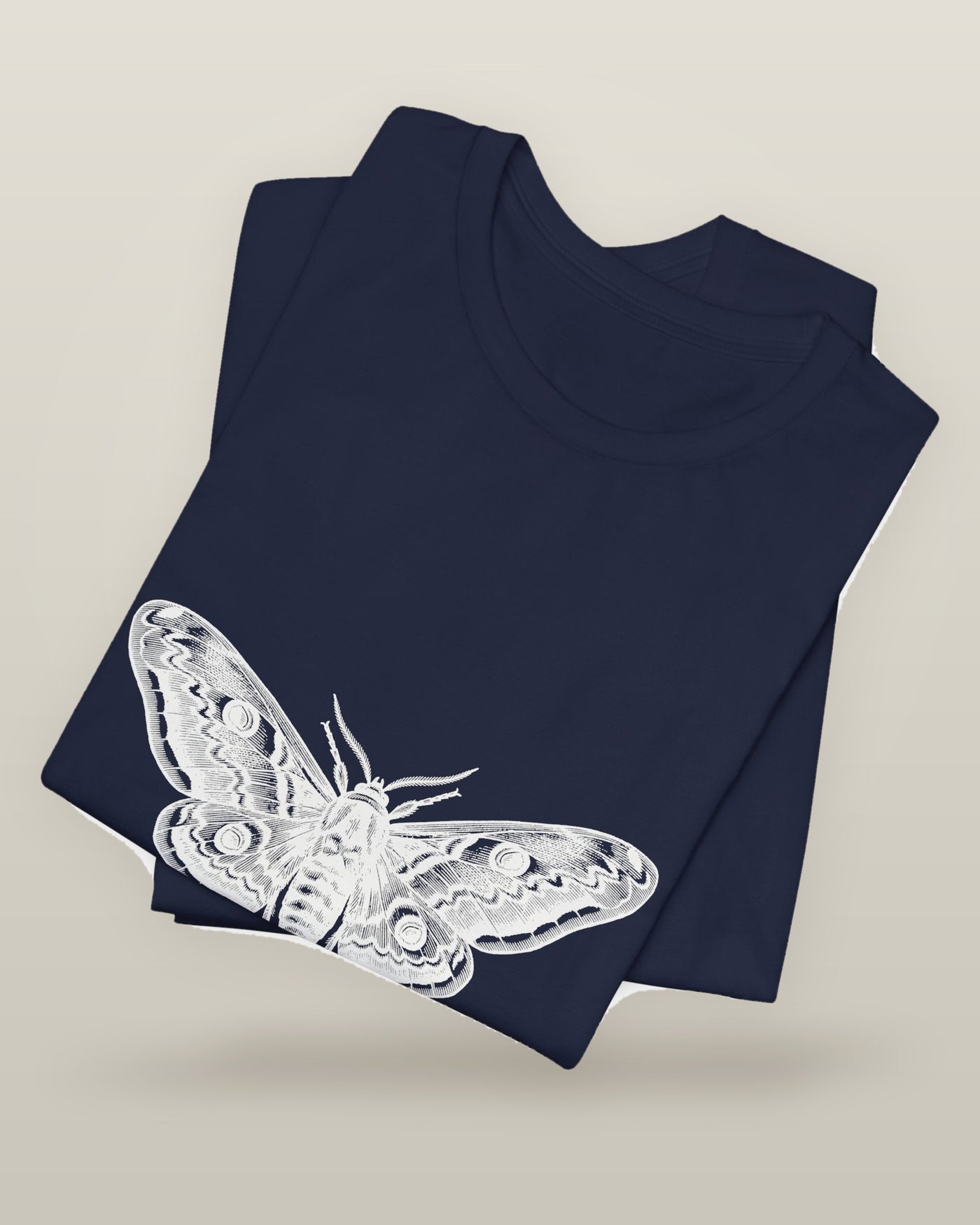 Every light looked like the sun — a moth specimen study, wings spread, printed on a navy cotton t-shirt, folded
