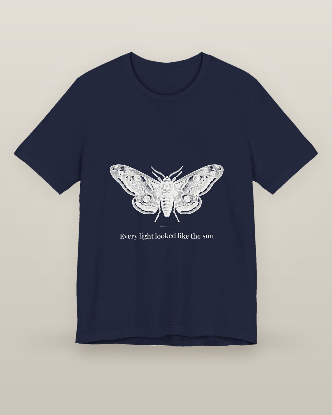Every light looked like the sun — a moth specimen study, wings spread, printed on a navy cotton t-shirt, front view