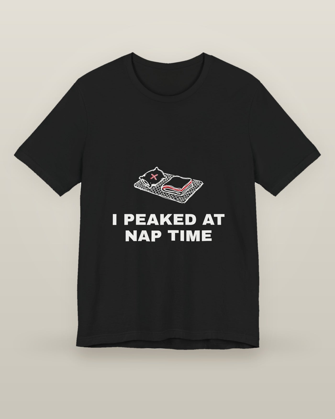 I peaked at nap time — a floor nap mat with a folded blanket and one pillow, printed on a black cotton t-shirt, front view