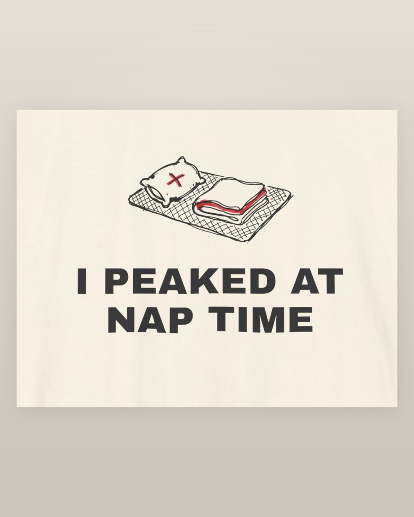 I peaked at nap time — a floor nap mat with a folded blanket and one pillow, printed on a natural cream cotton t-shirt, close detail of the print