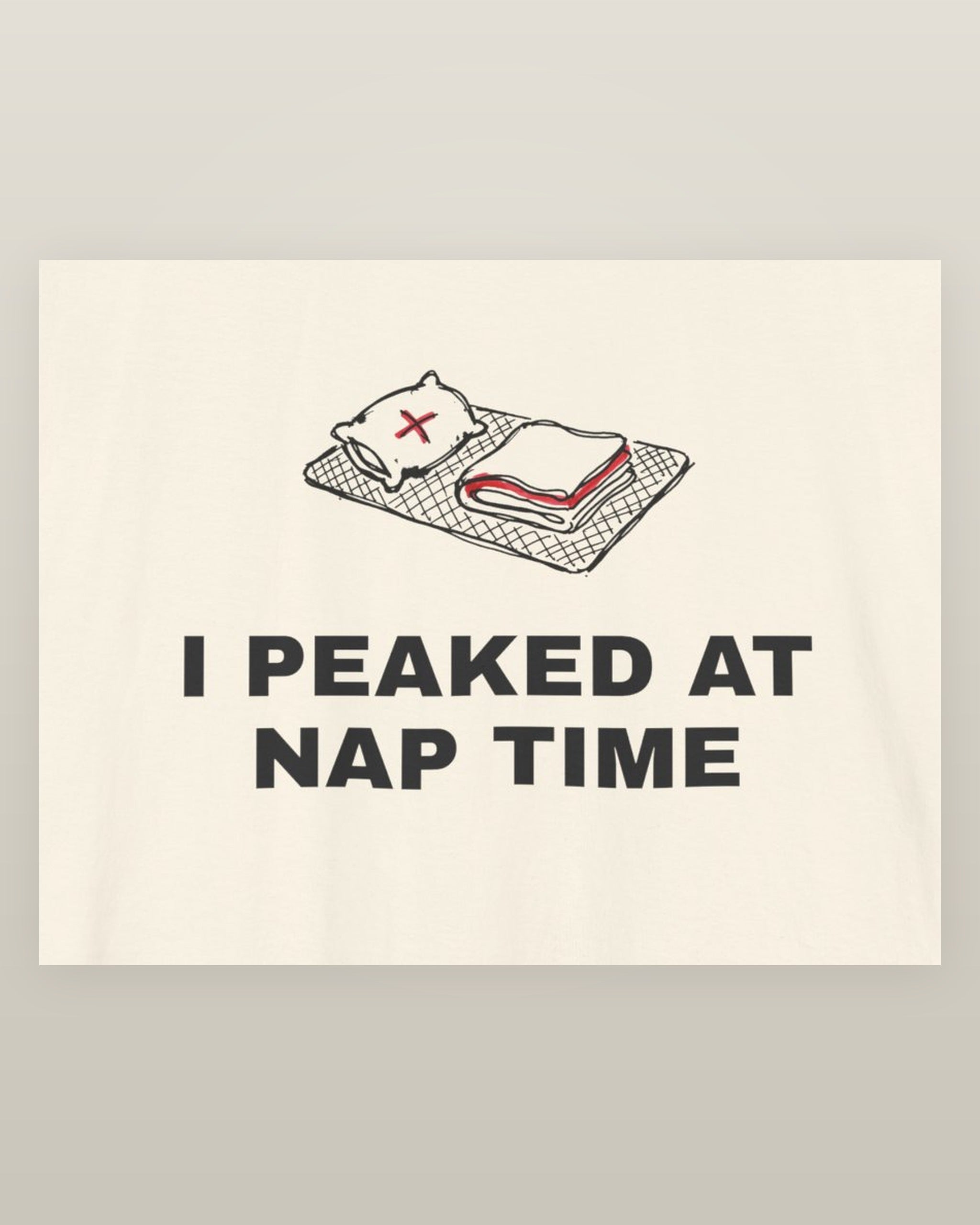 I peaked at nap time — a floor nap mat with a folded blanket and one pillow, printed on a natural cream cotton t-shirt, close detail of the print