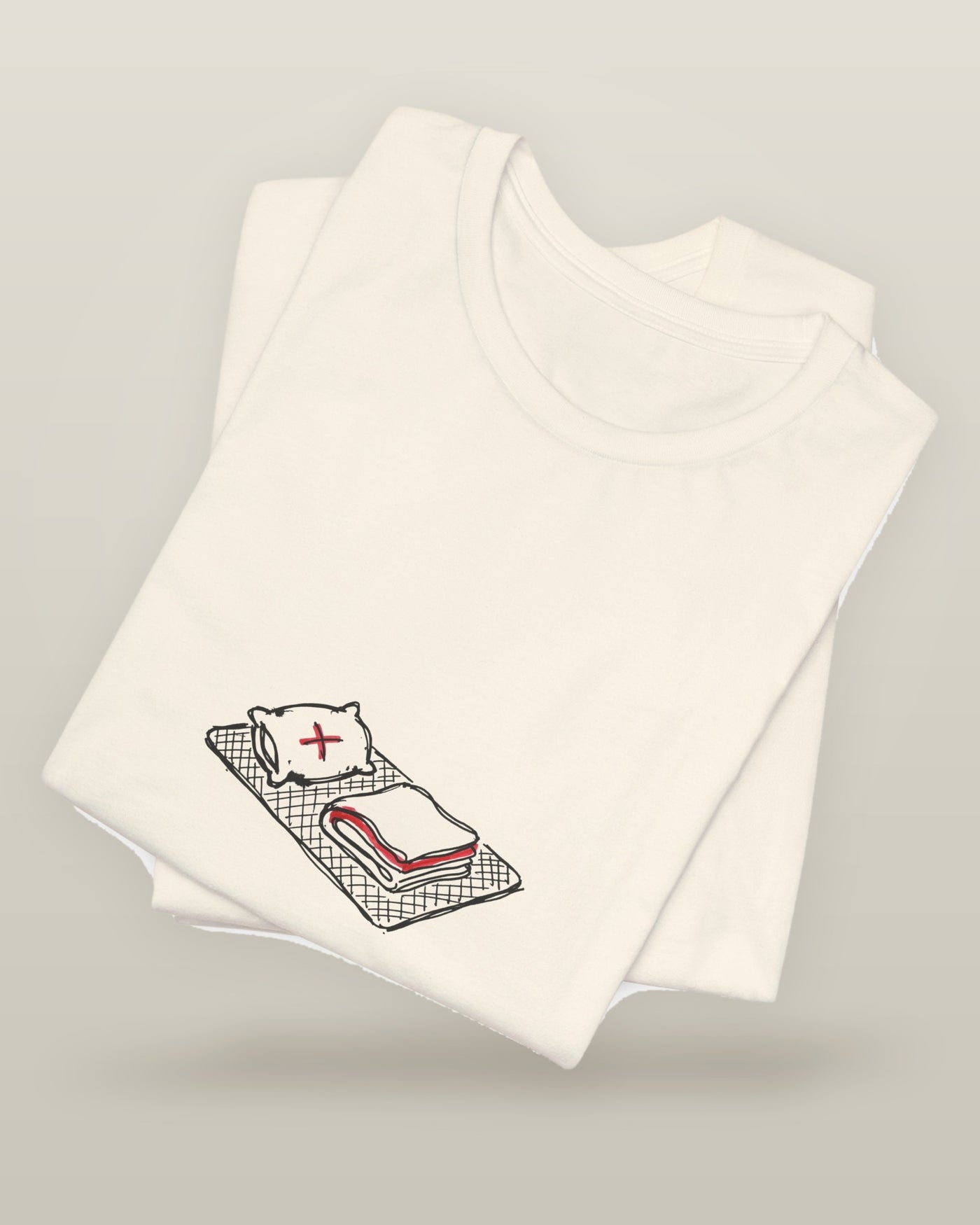 I peaked at nap time — a floor nap mat with a folded blanket and one pillow, printed on a natural cream cotton t-shirt, folded