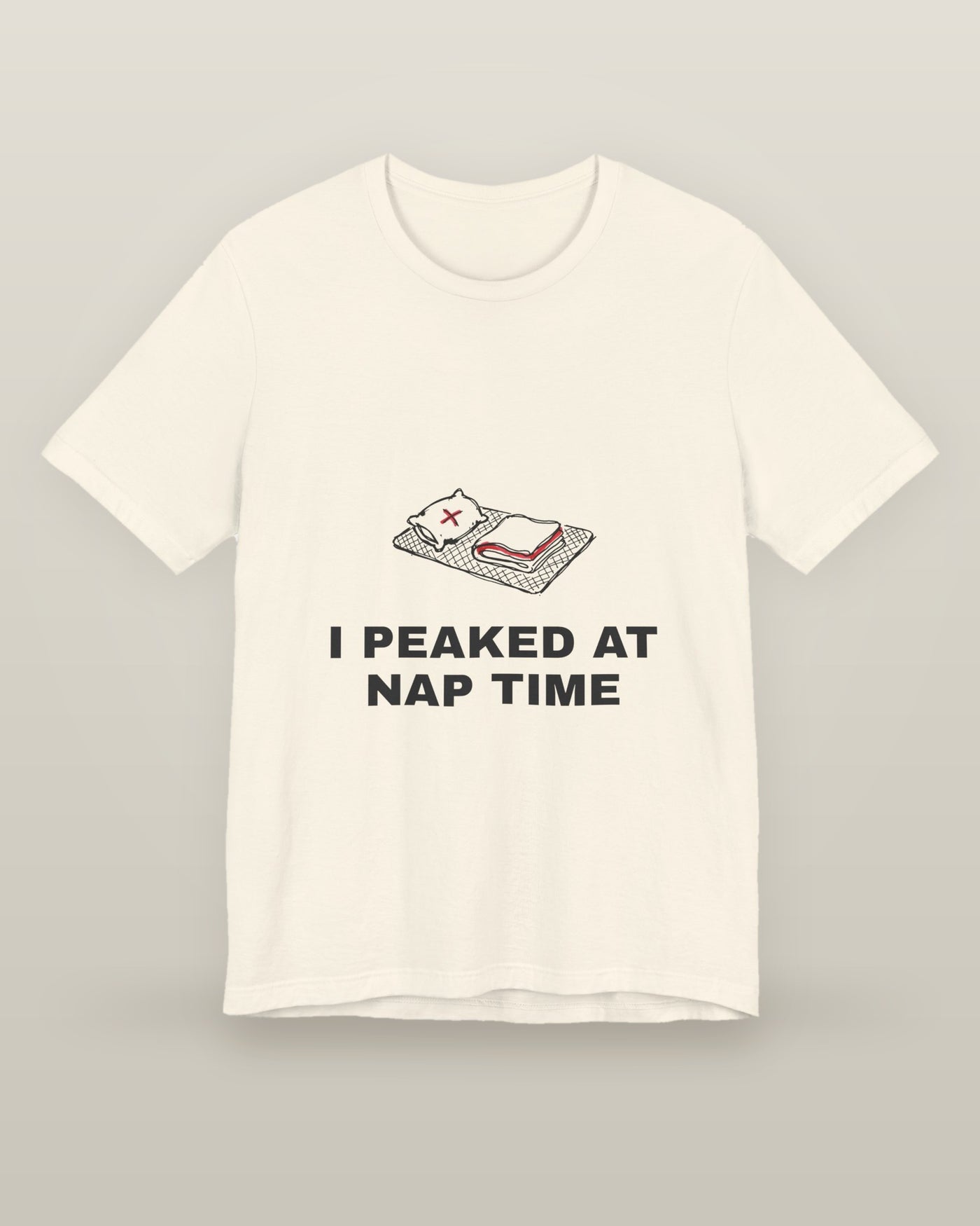 I peaked at nap time — a floor nap mat with a folded blanket and one pillow, printed on a natural cream cotton t-shirt, front view