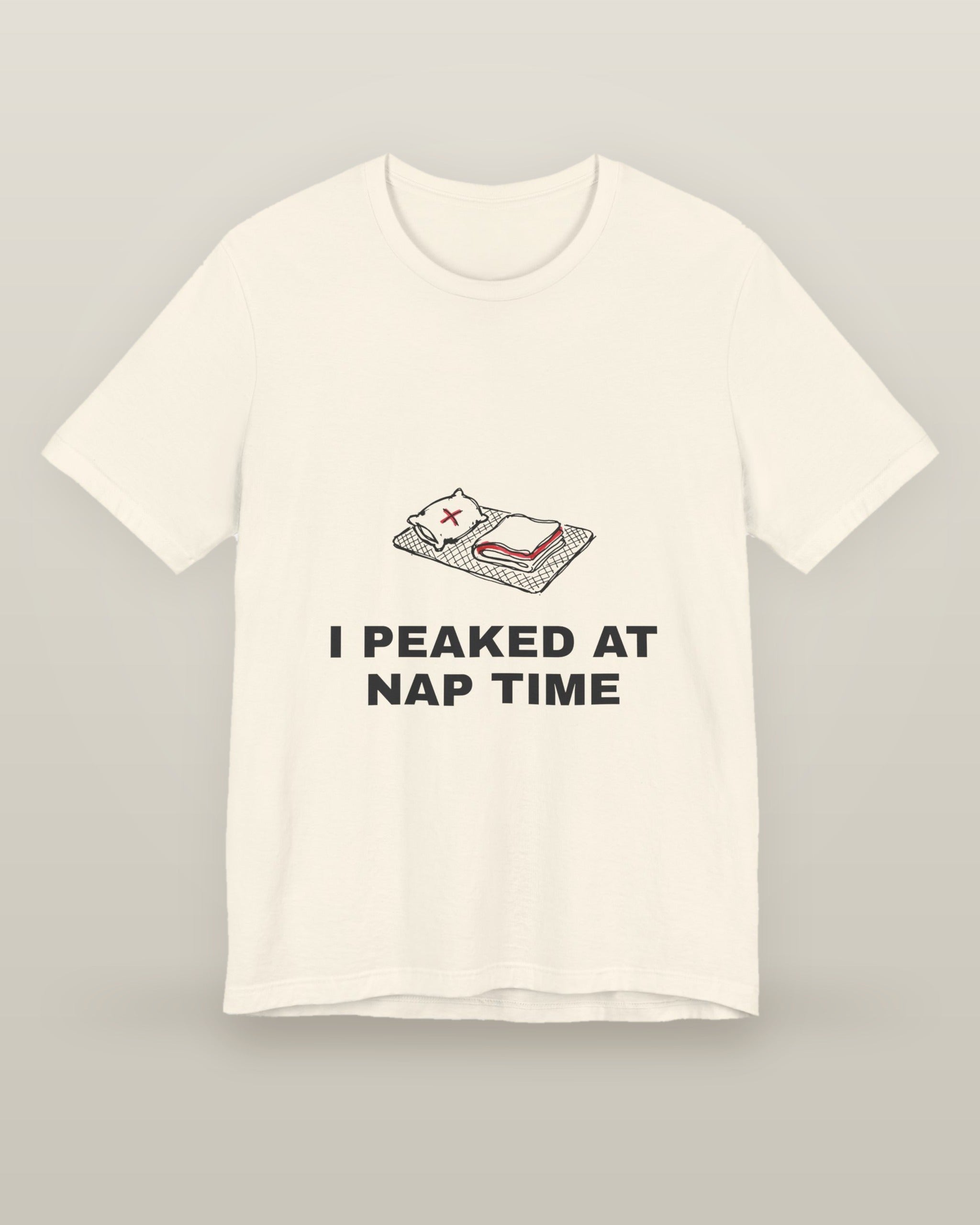 I peaked at nap time — a floor nap mat with a folded blanket and one pillow, printed on a natural cream cotton t-shirt, front view