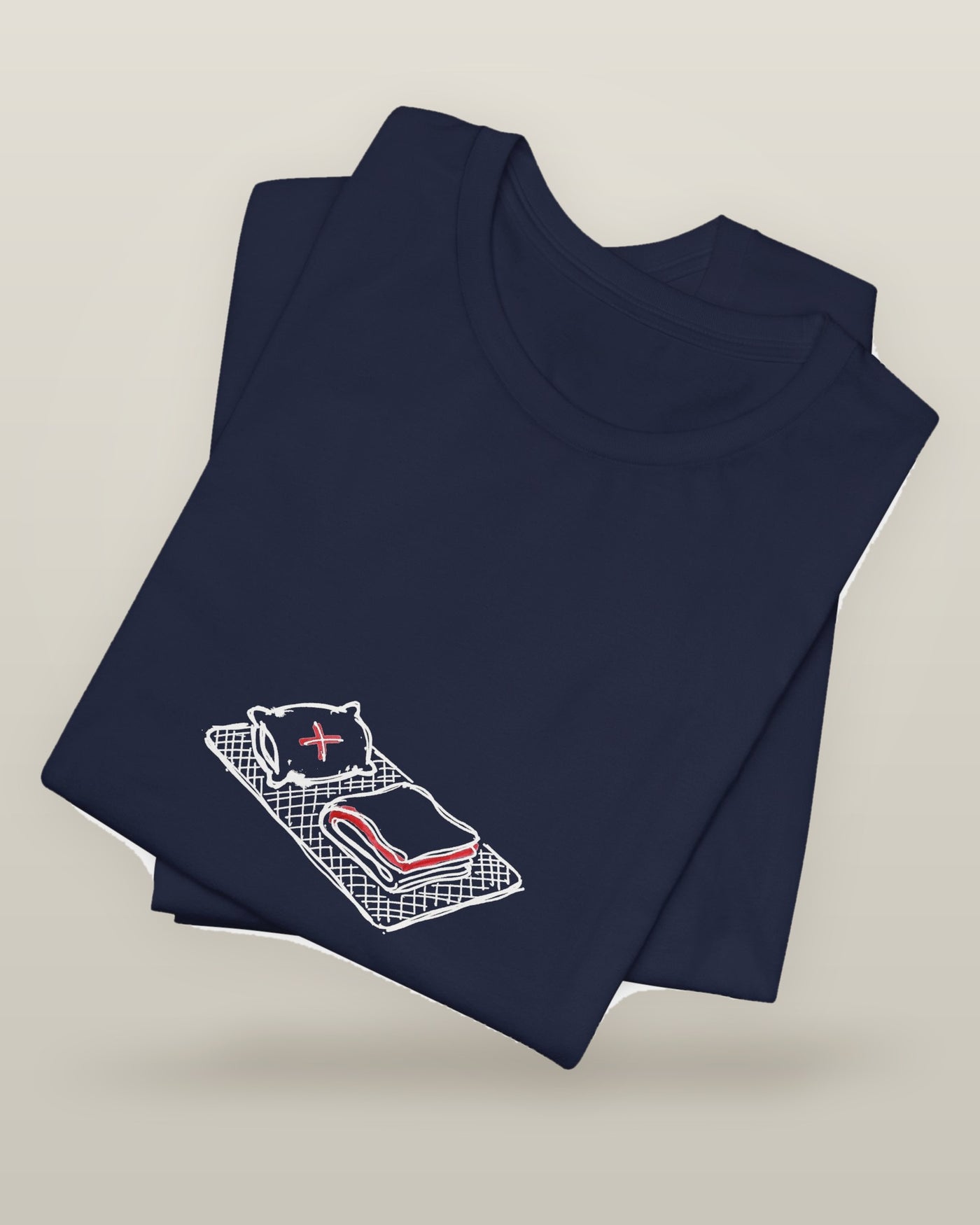 I peaked at nap time — a floor nap mat with a folded blanket and one pillow, printed on a navy cotton t-shirt, folded