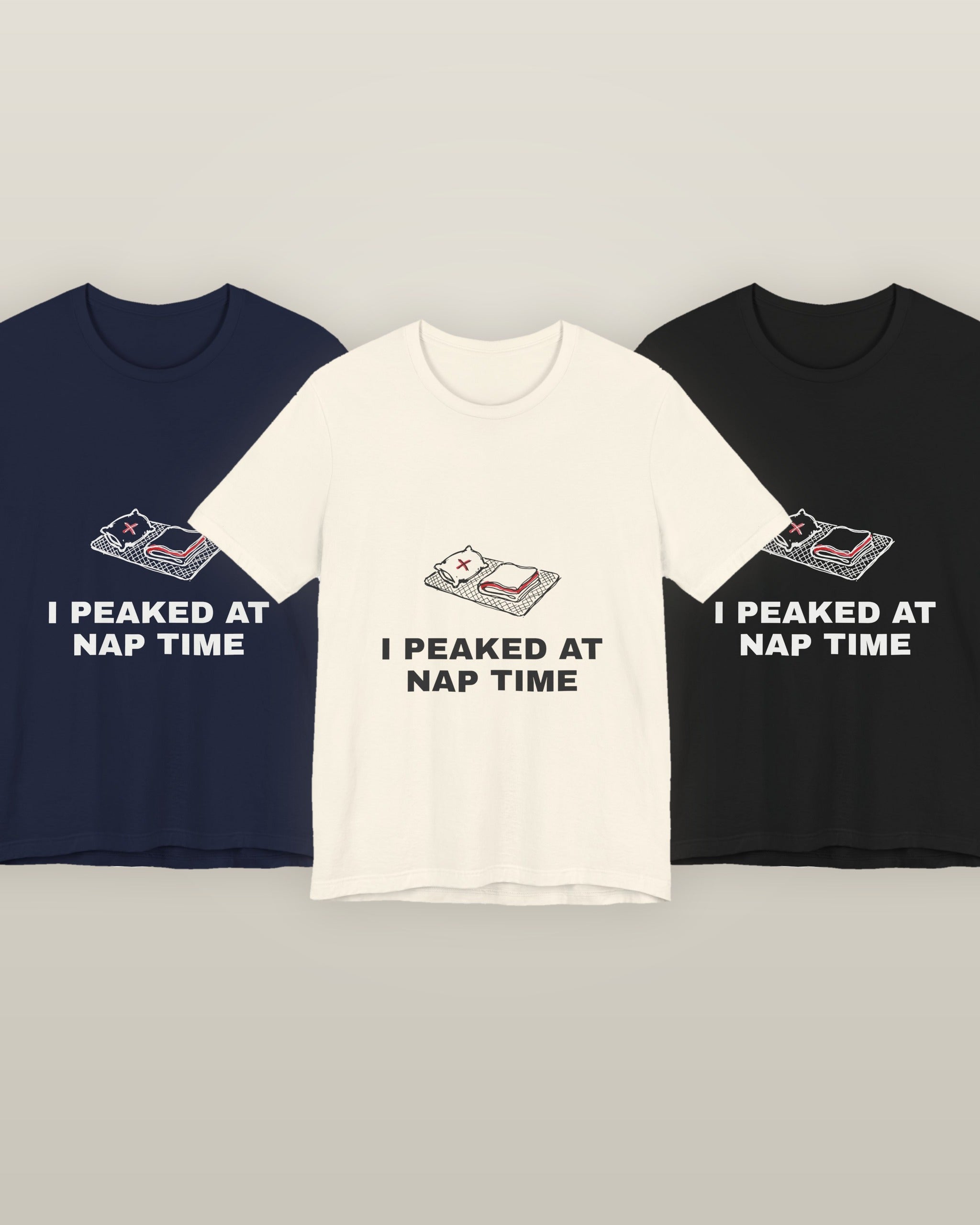 I peaked at nap time — a floor nap mat with a folded blanket and one pillow, printed on a natural cream, navy and black cotton t-shirt, all three colourways together