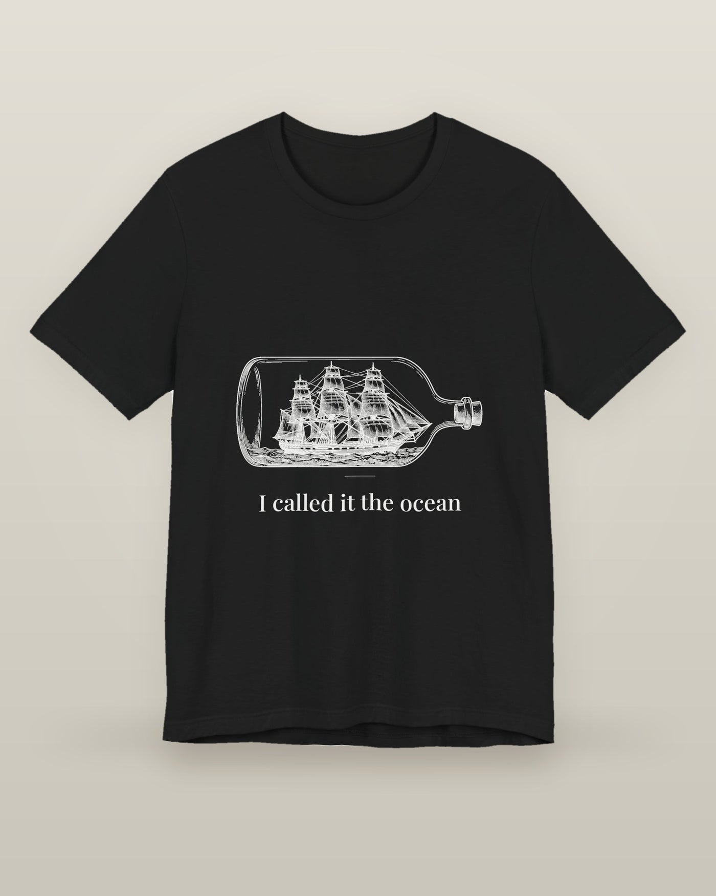 I called it the ocean — a full-rigged ship sealed in a glass bottle, printed on a black cotton t-shirt, front view