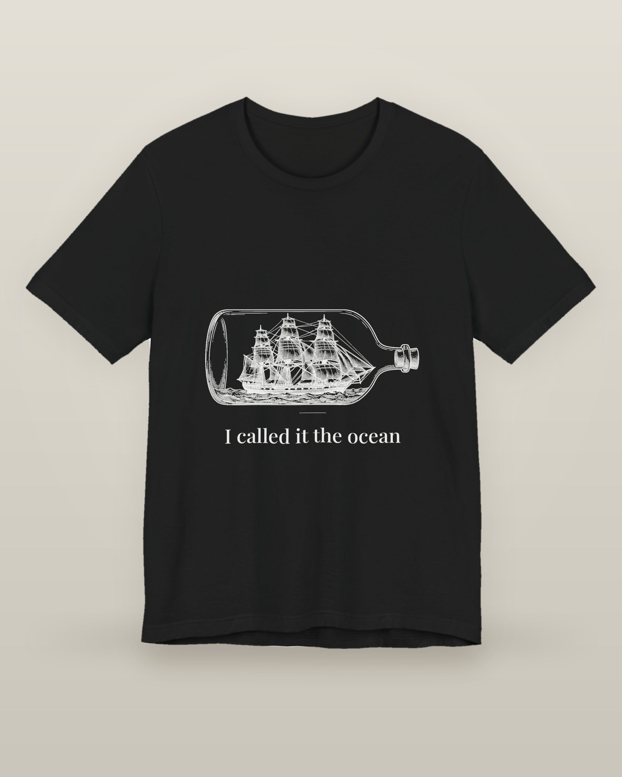 I called it the ocean — a full-rigged ship sealed in a glass bottle, printed on a black cotton t-shirt, front view