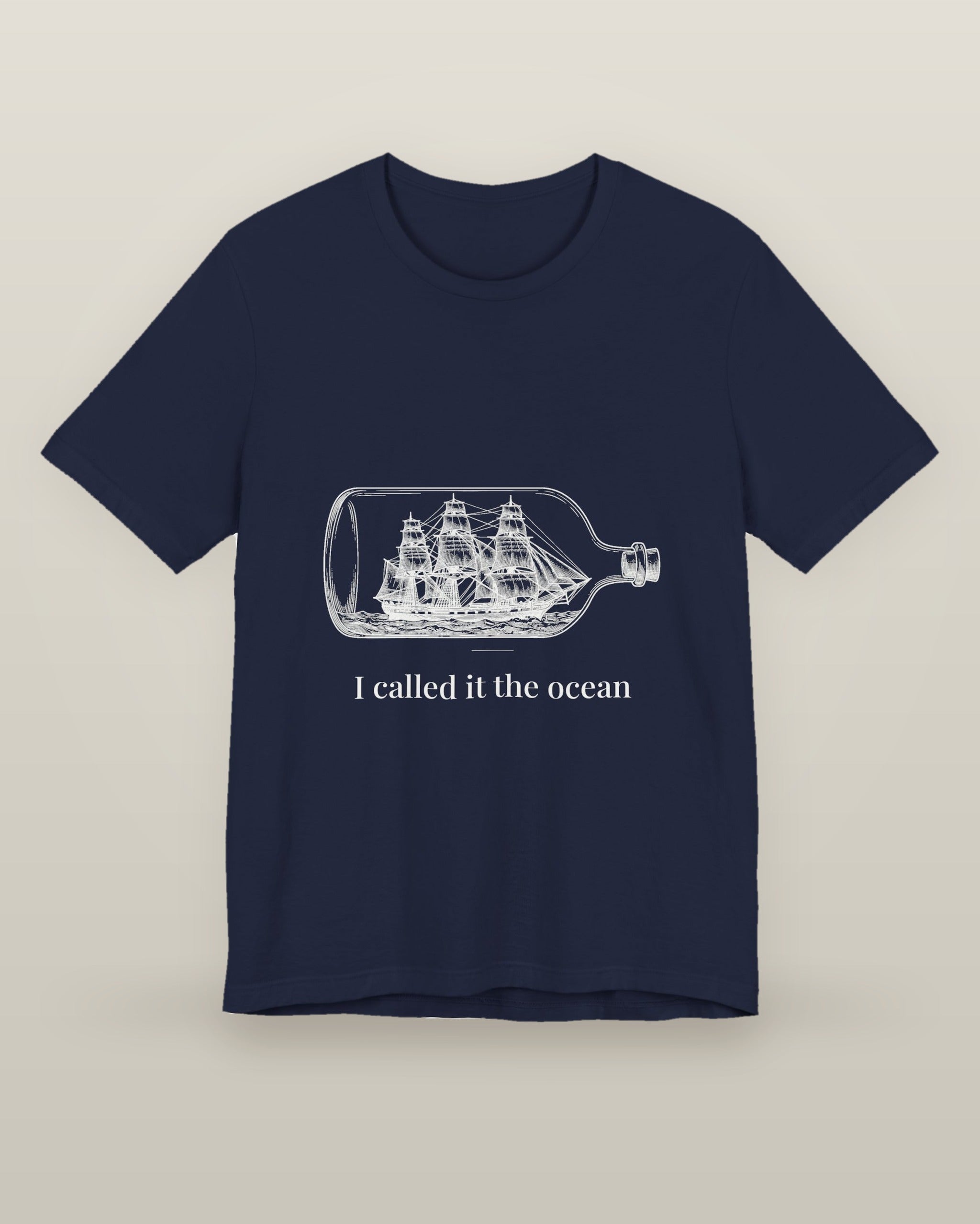 I called it the ocean — a full-rigged ship sealed in a glass bottle, printed on a navy cotton t-shirt, front view