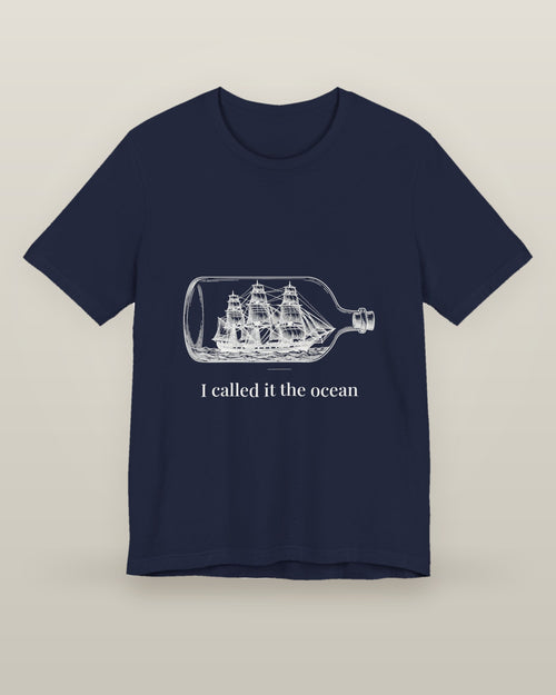 I called it the ocean — a full-rigged ship sealed in a glass bottle, printed on a navy cotton t-shirt, front view