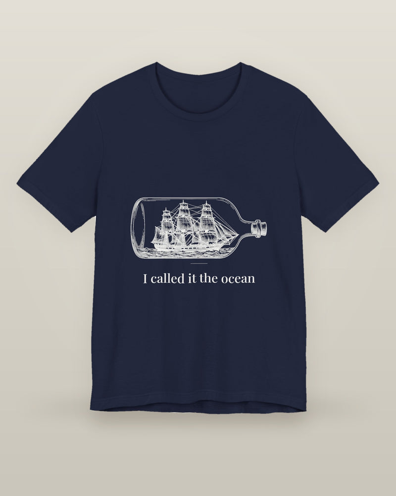 I called it the ocean — a full-rigged ship sealed in a glass bottle, printed on a navy cotton t-shirt, front view