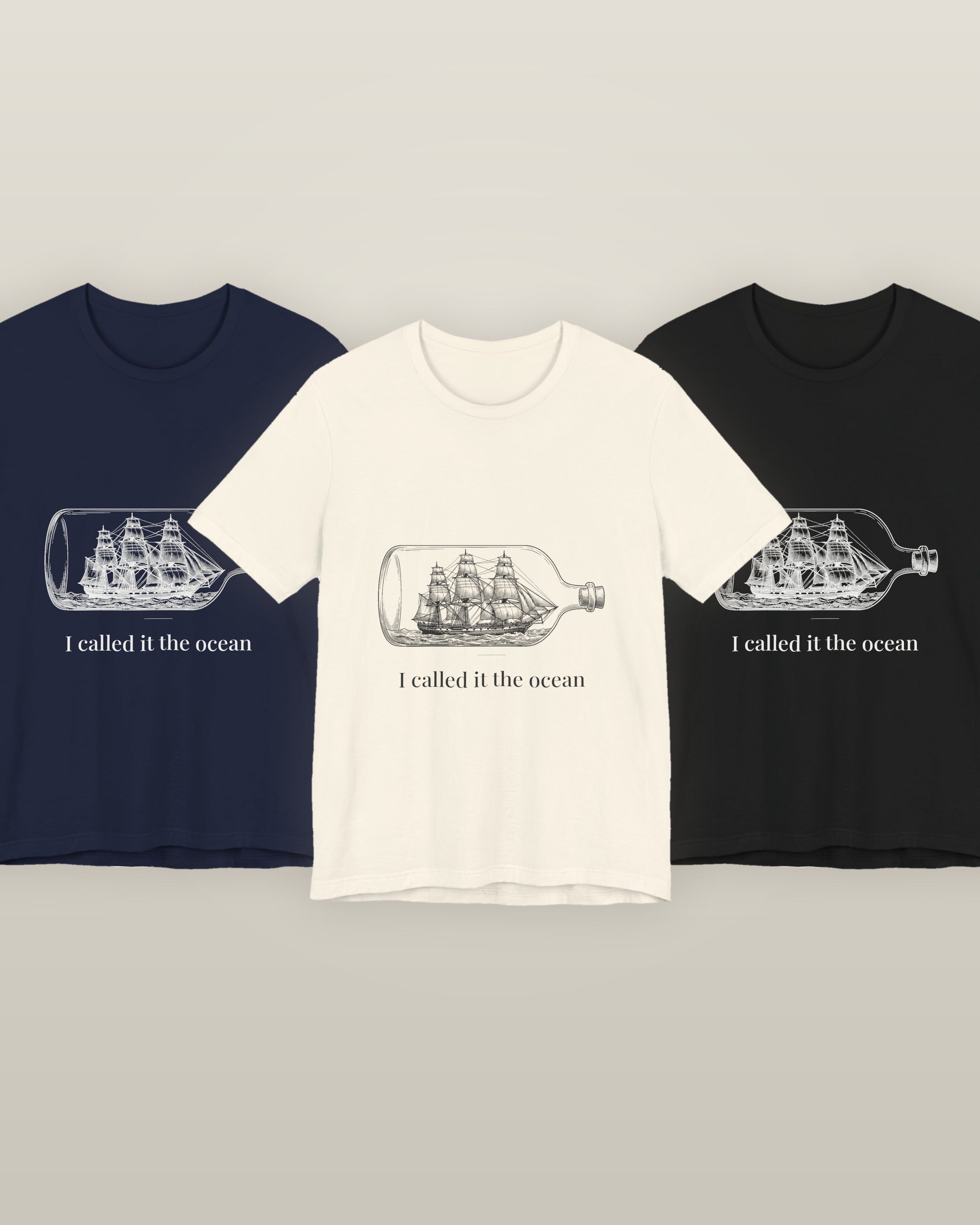I called it the ocean — a full-rigged ship sealed in a glass bottle, printed on a natural cream, navy and black cotton t-shirt, all three colourways together