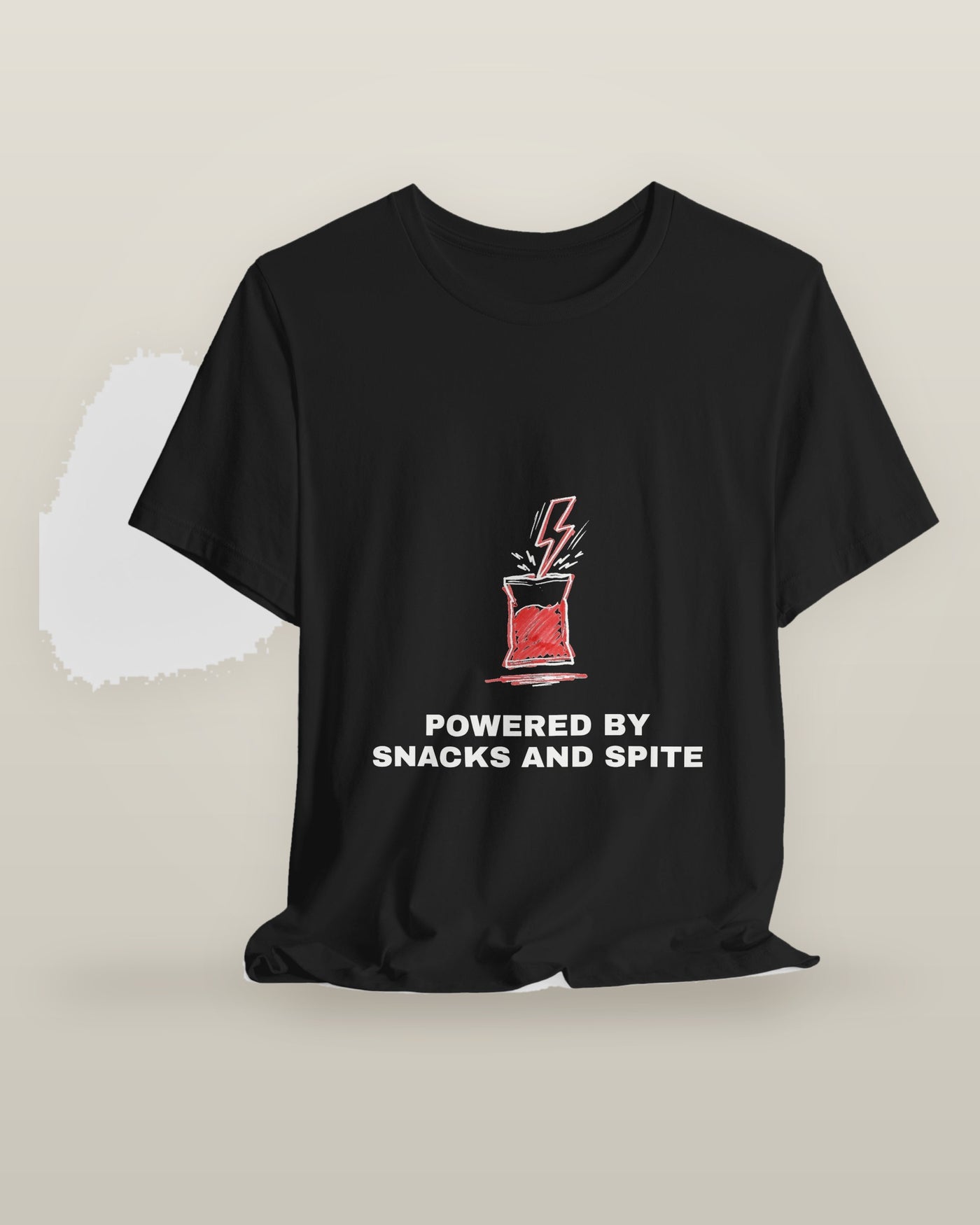 Powered by snacks and spite — a crisp packet struck by a lightning bolt, printed on a black cotton t-shirt, on a hanger