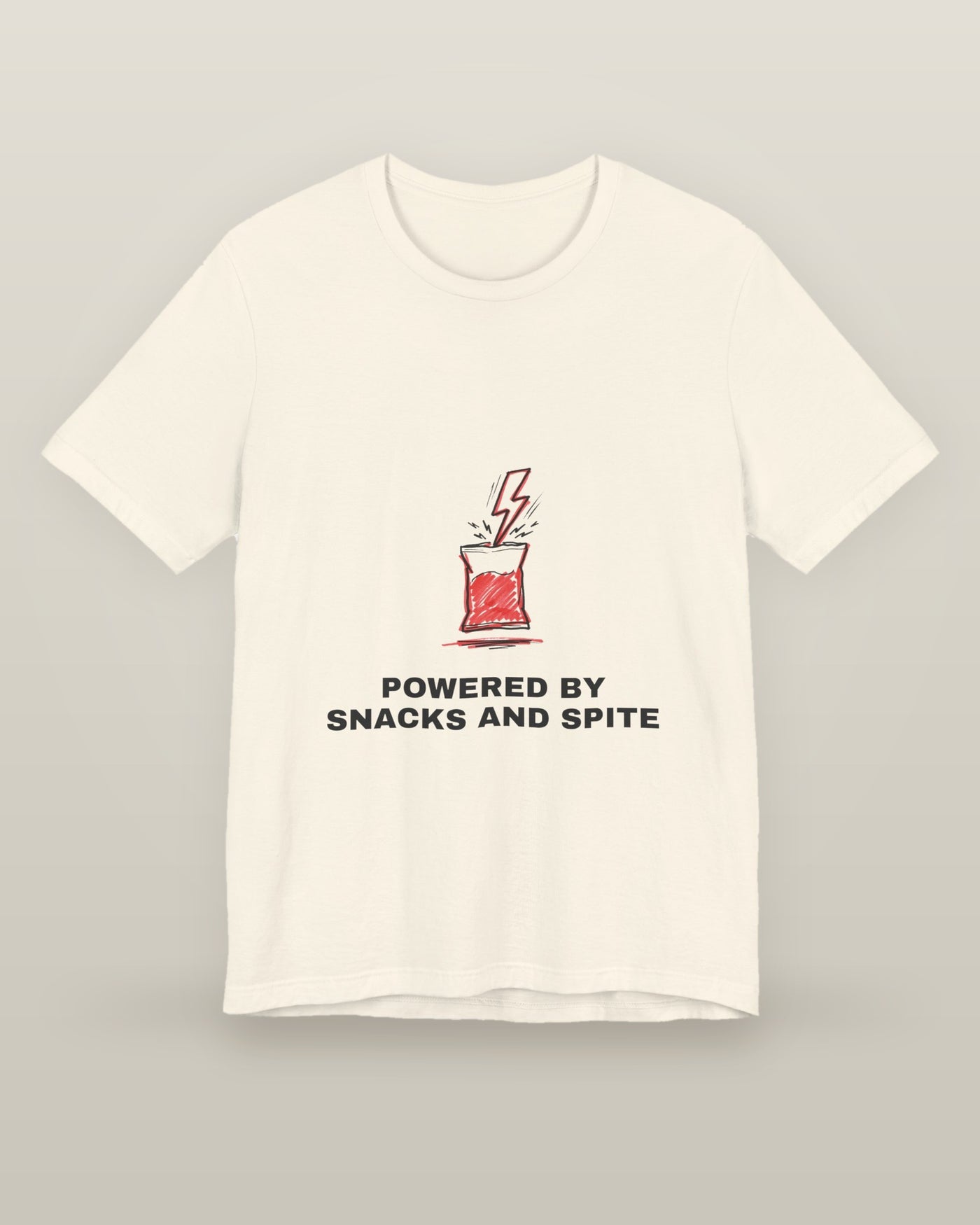 Powered by snacks and spite — a crisp packet struck by a lightning bolt, printed on a natural cream cotton t-shirt, front view