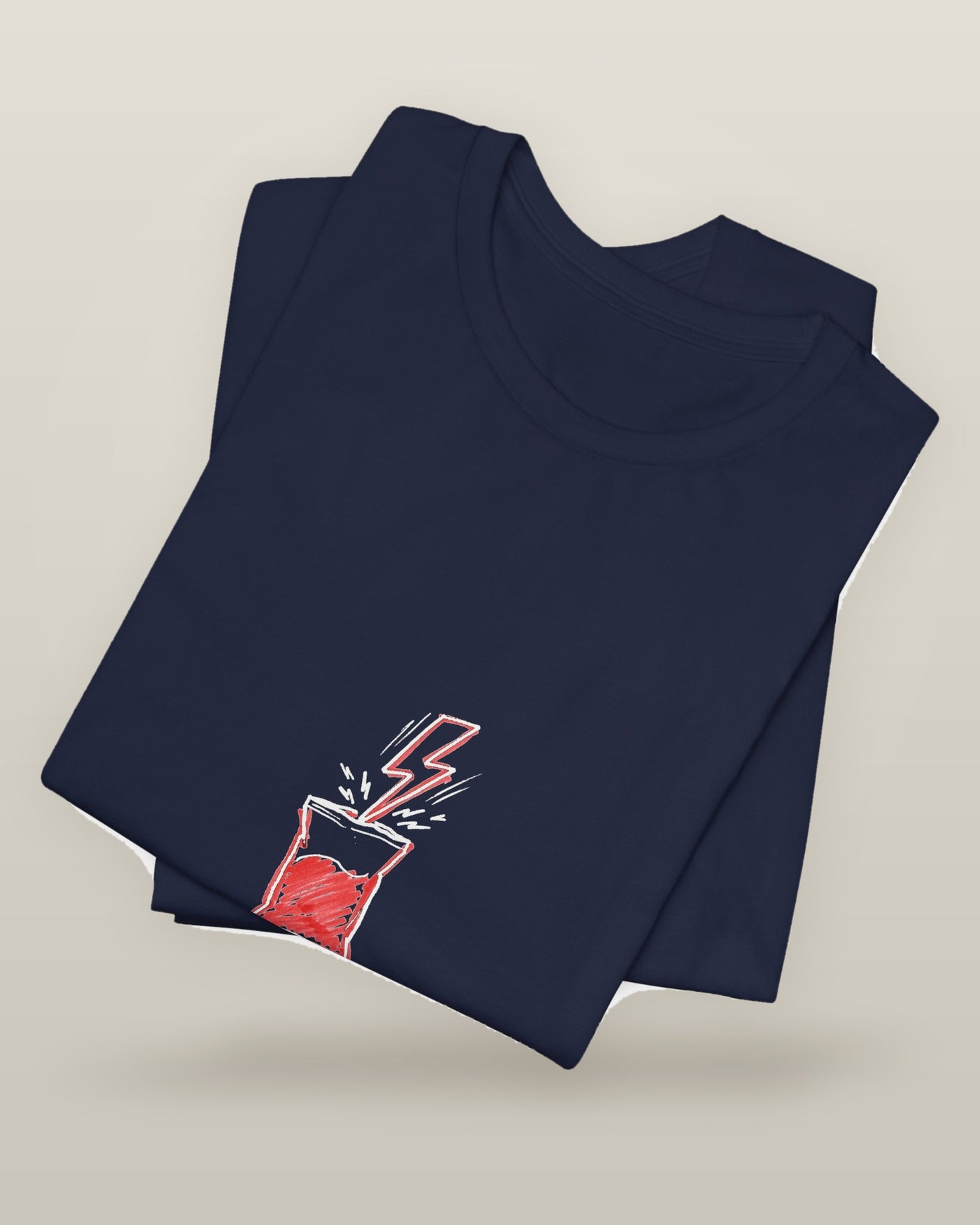 Powered by snacks and spite — a crisp packet struck by a lightning bolt, printed on a navy cotton t-shirt, folded