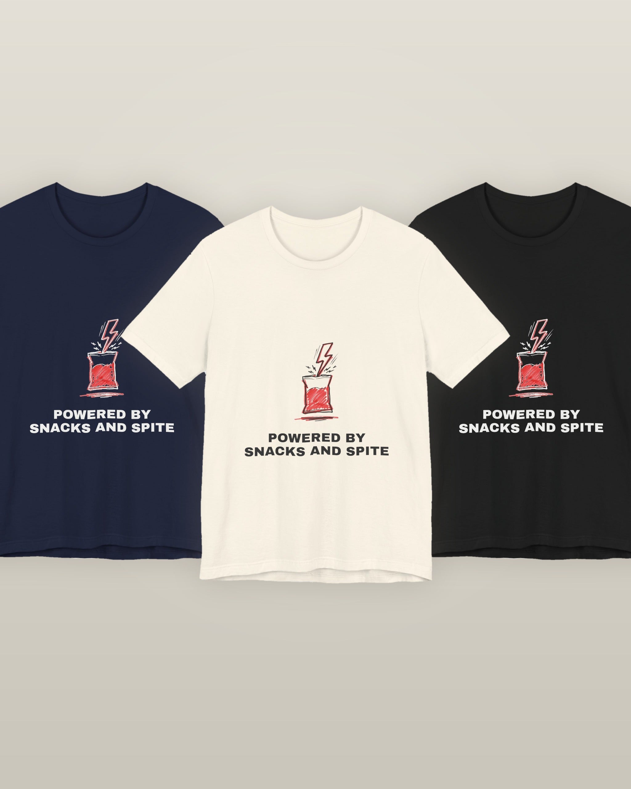 Powered by snacks and spite — a crisp packet struck by a lightning bolt, printed on a natural cream, navy and black cotton t-shirt, all three colourways together